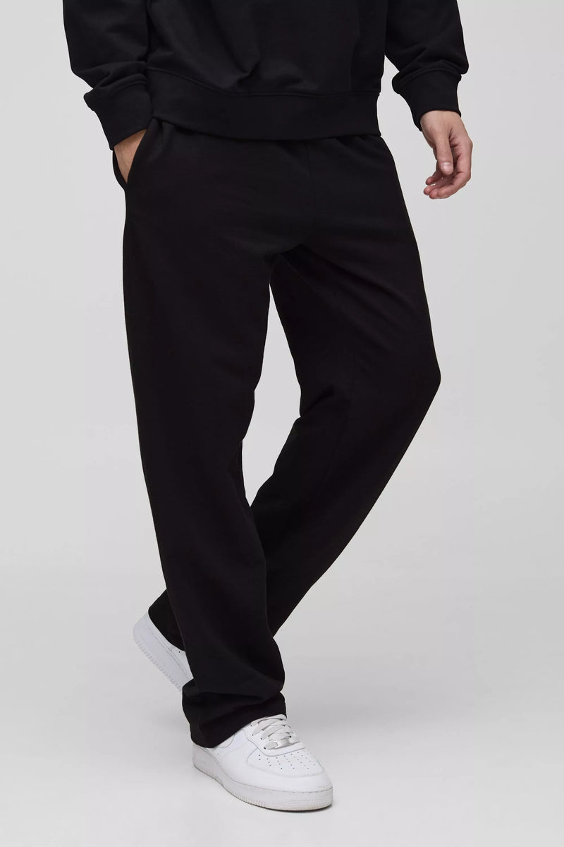 Black straight-fit trousers worn by a model