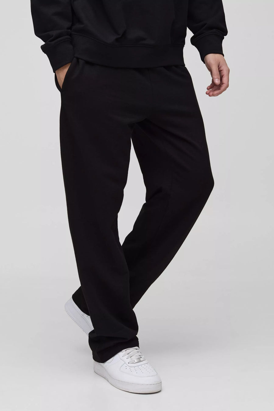 Black straight-fit trousers worn by a model