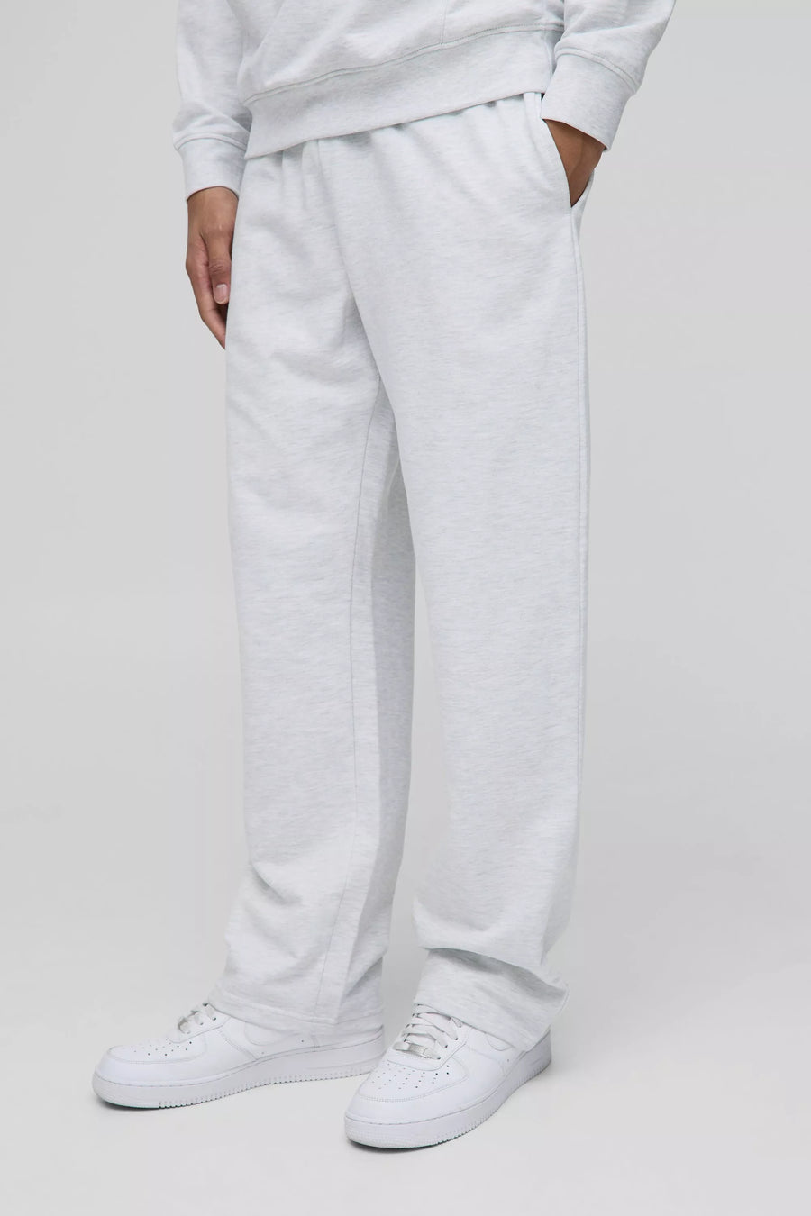 Light grey straight-fit trousers worn by a model